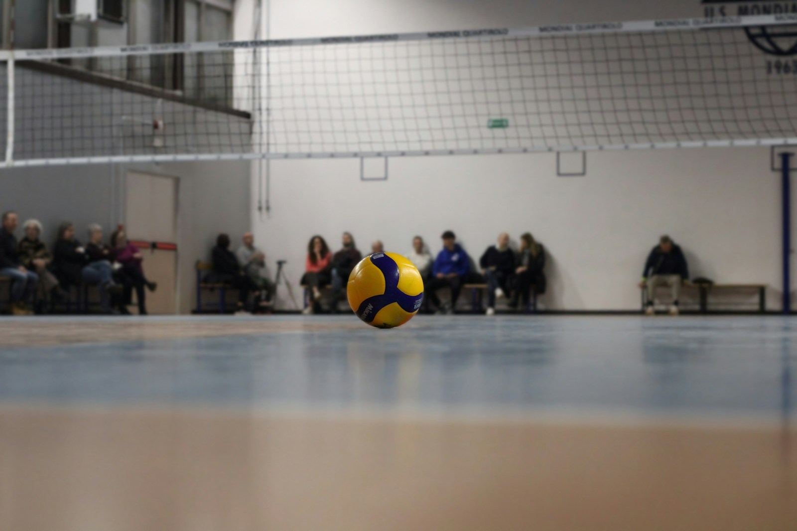 Volleyball resting on a gym floor